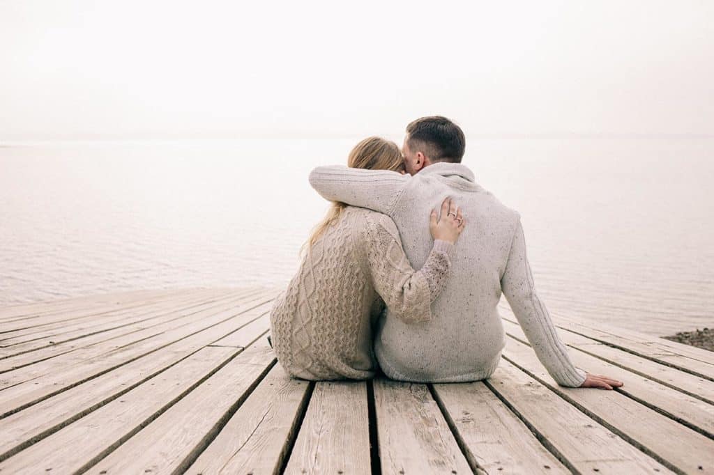 couple hugging on a pier