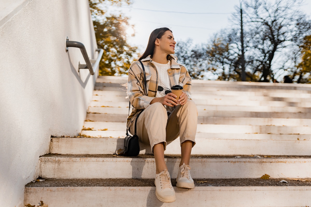 attractive young woman walking in autumn wearing jacket