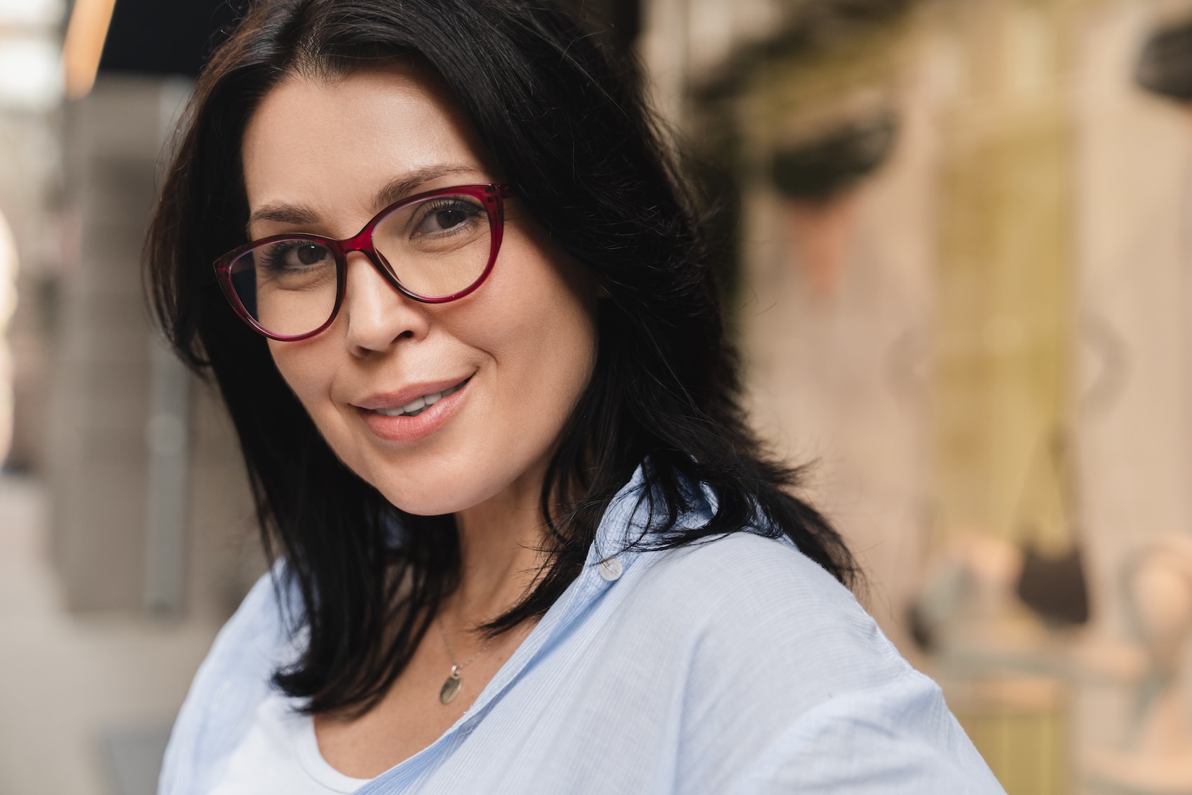 Beautiful caucasian middle-aged mature woman with dark brown hair looking at camera