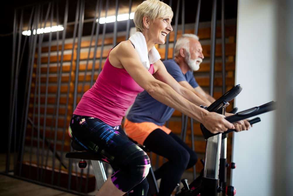 mature couple enjoying excercising together and smiling after visiting christimd as their hormone doctor in houston tx