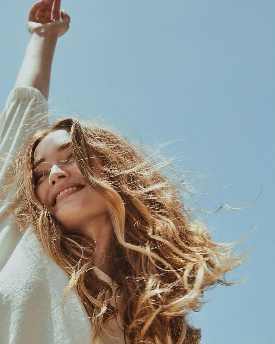 A beautiful woman raising her arms