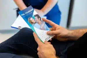 A patient holds a pamphlet about female BHRT in Houston.