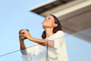 A woman enjoying fresh air outside after her appointment with our urogynecologist in Houston.