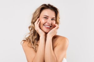 A woman who saw Dr. Christi, our urogynecologist in Houston for aesthetic services, smiles.